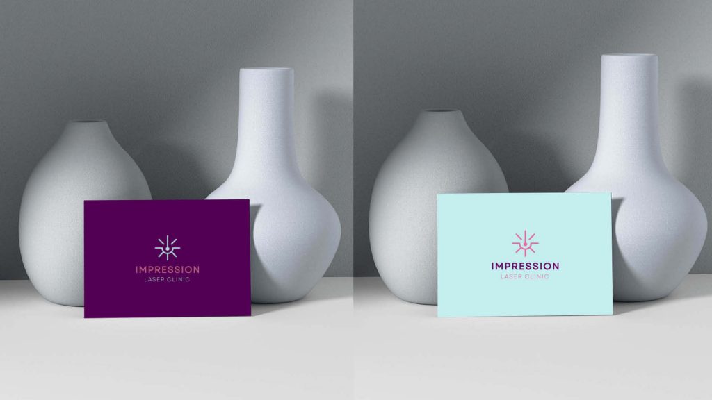 Laser clinic logo on a business card next to decorative vases, showcasing a sophisticated and professional branding style.
