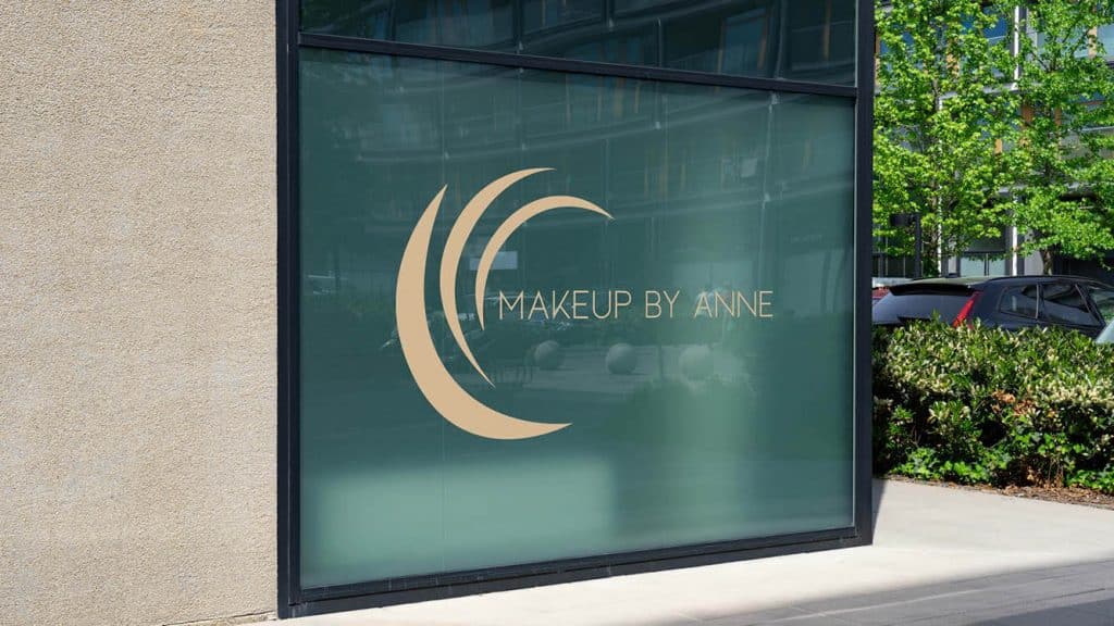 Logo design for a makeup artist displayed in a shop window, highlighting creative and personalized branding.