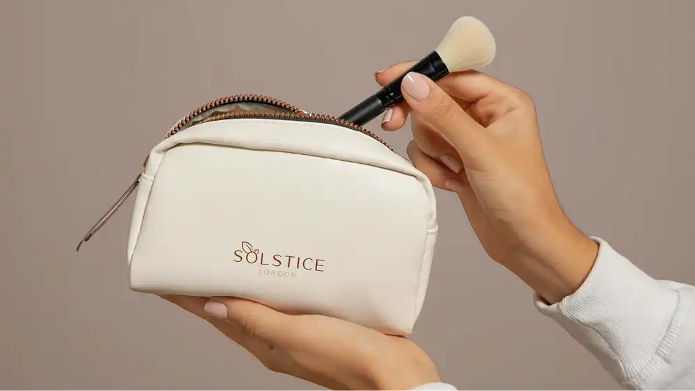 Chic beauty brand logo on a white cosmetic bag, perfect for modern cosmetic branding.