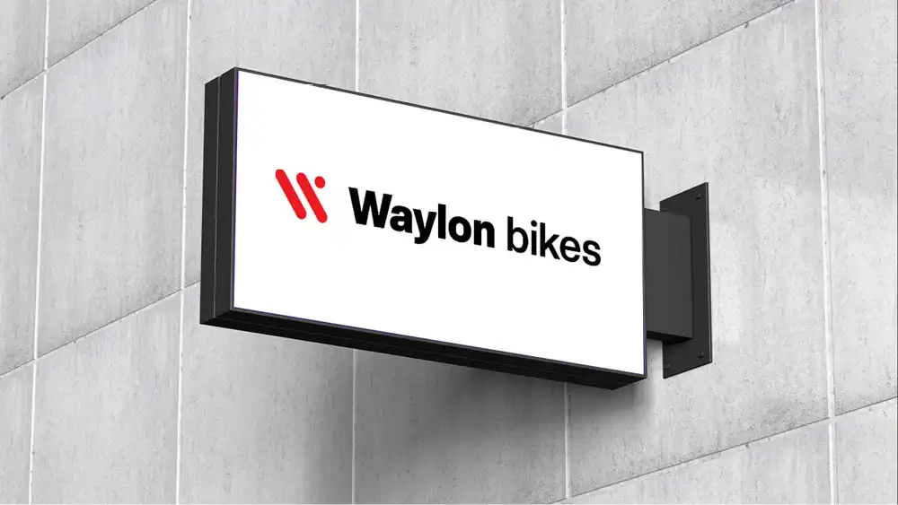 Bold bike logo design on a wall sign, crafted to capture the spirit of cycling brands.